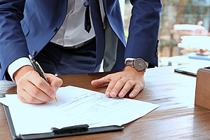 a life insurance consultant signing a document to protect the estate of an individual