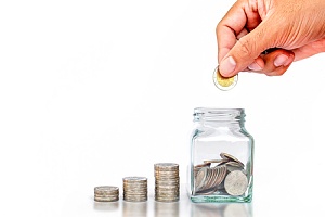 a man saving coins in a glass jar