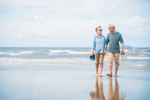 elderly couple walking the beach
