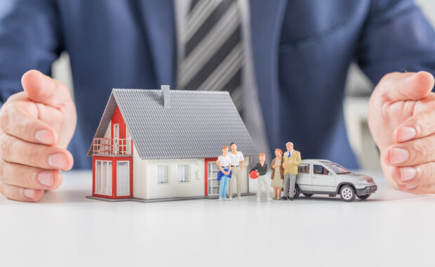 figurines of a family with a house and car representing estate protection