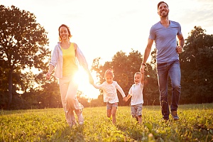 parents playing with their kids in a field