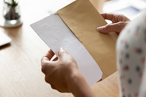 women opening mail from life insurance agency