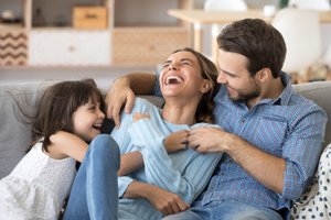 Family consisting man woman and girl laughing