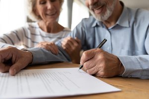 Old man reading process of life insurance before signing