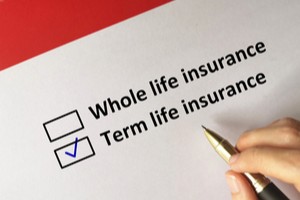 Whole life insurance term life insurance written on paper while hand ticking later option