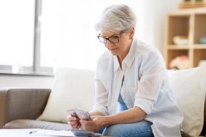 old lady counting savings money