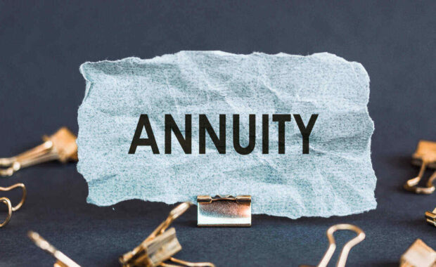 scrap of blue paper with clips on a gray background with the text annuity