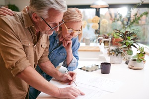 couple reviewing and signing domestic finances and investment paperwork