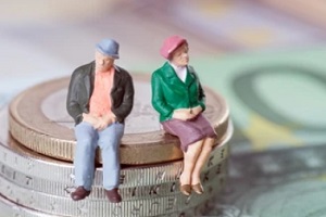 old couple sitting on coin stack