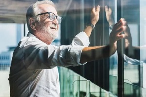 retired old man looking out of window