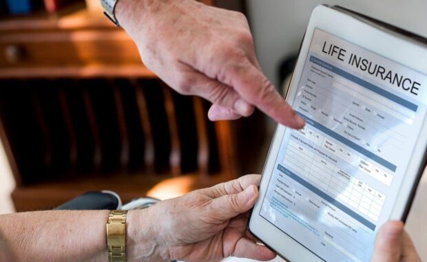 couple reading life insurance form in tablet