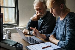 elder couple calculating insurance premium
